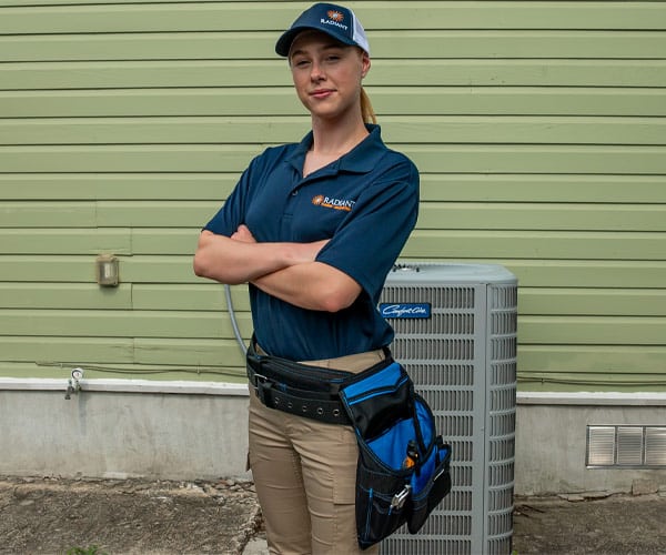 Radiant of Austin Air Conditioning Technician standing in from of AC unit
