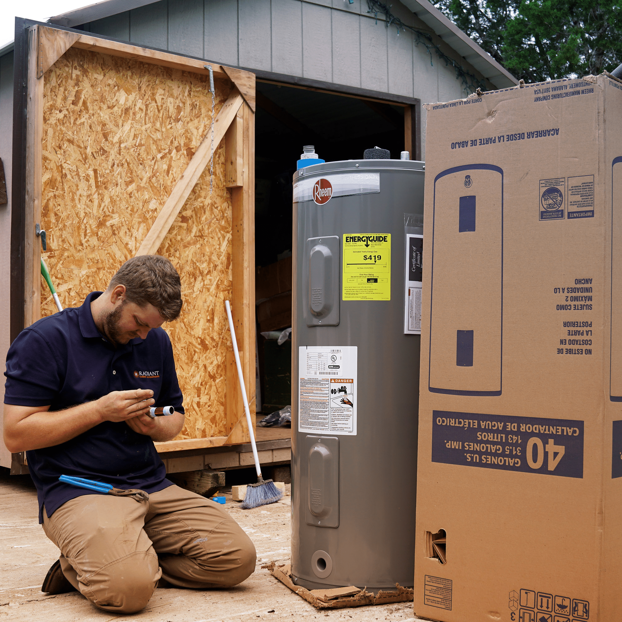 A Radiant plumber inspecting a new water heater before installation