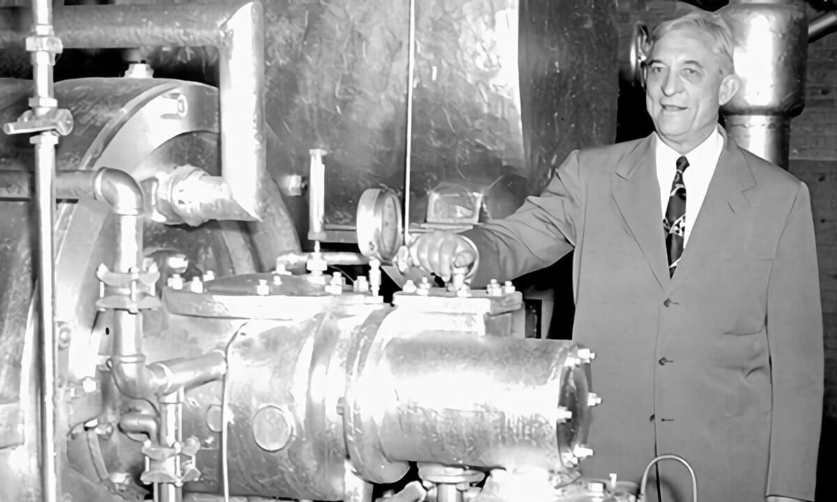 A black and white photo of a man with an ac unit