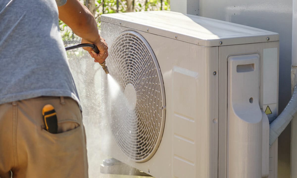 Cleaning the outdoor AC unit with a hose