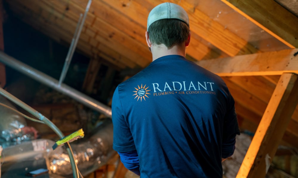 Radiant HVAC technician improving indoor air quality by working in the attic of a home in Austin, TX.