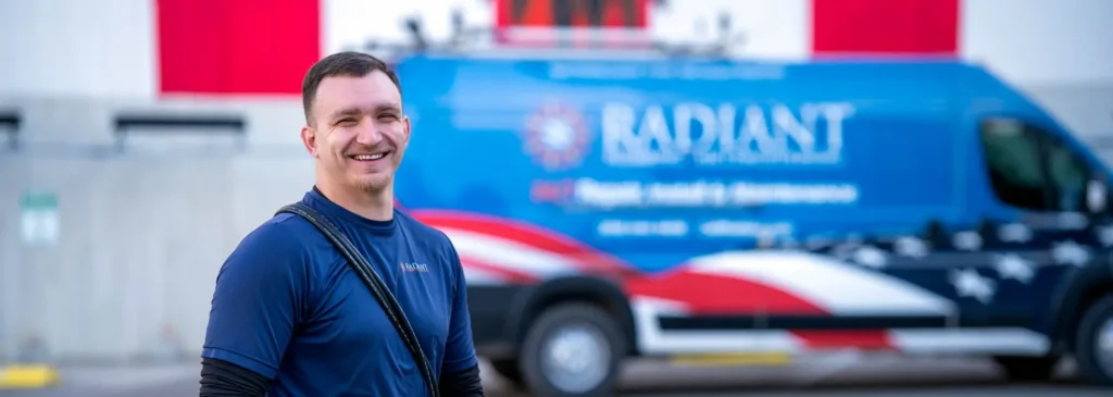 Smiling Radiant furnace installation technician in front of a Radiant service van in San Antonio