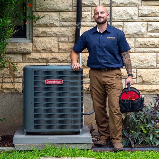 Radiant Technician standing next to an AC unit that's been recently installed.