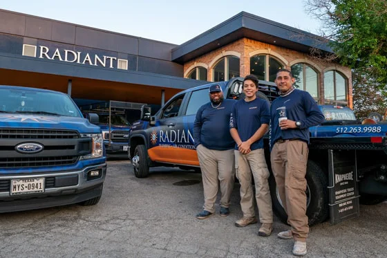 Radiant Plumbing and Air technicians standing in front of the office and trucks