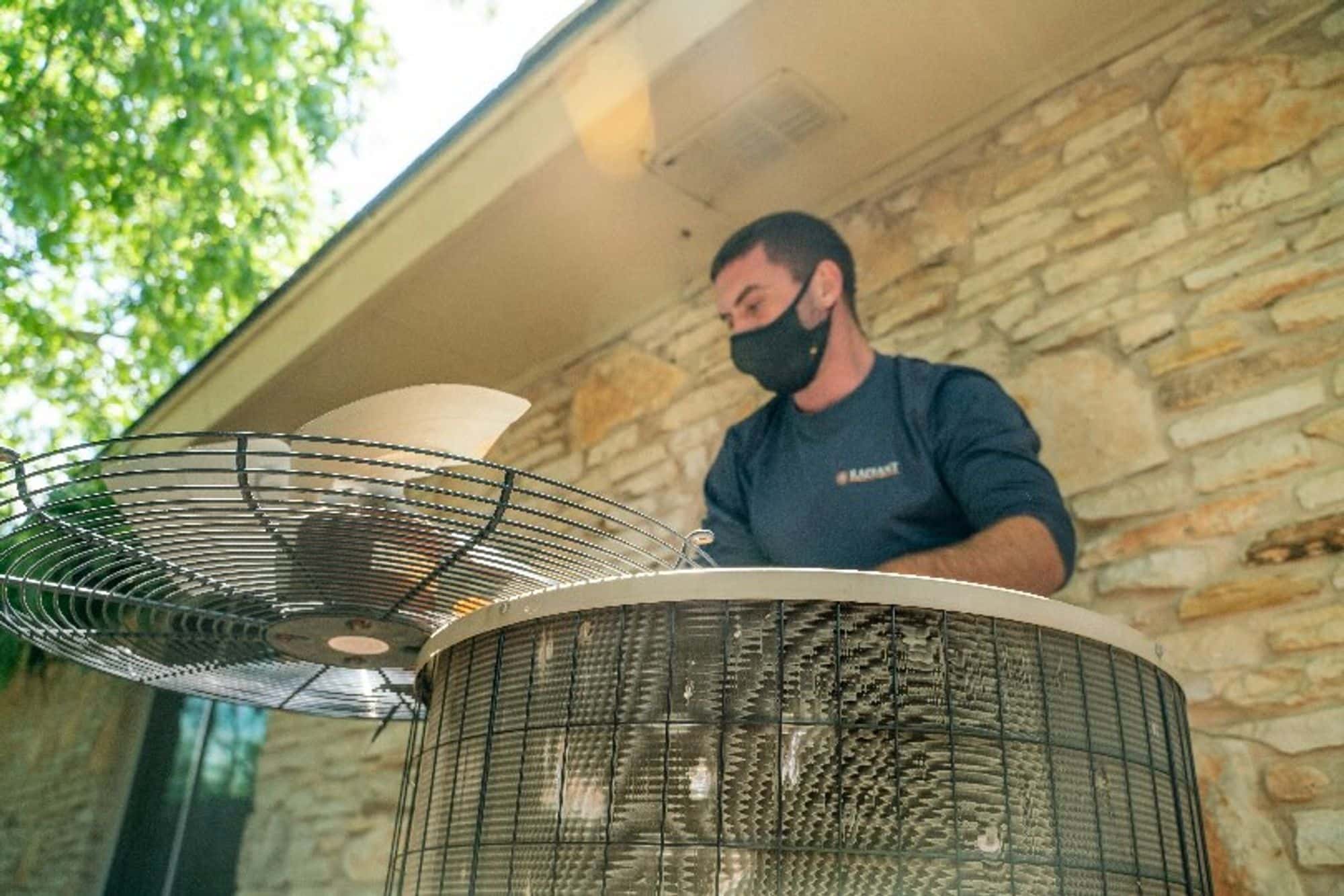 Radiant technician works on fixing an air conditioner at a home in Texas