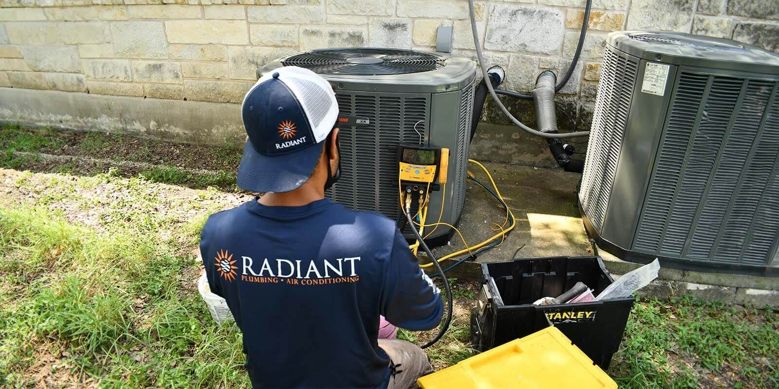 Radiant technician checking an outdoor HVAC unit