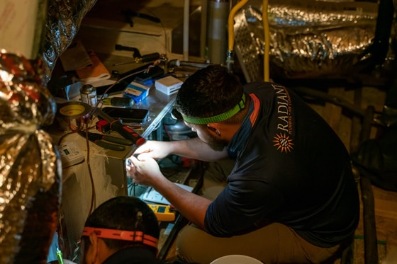 Radiant technician repairing an HVAC in an attic