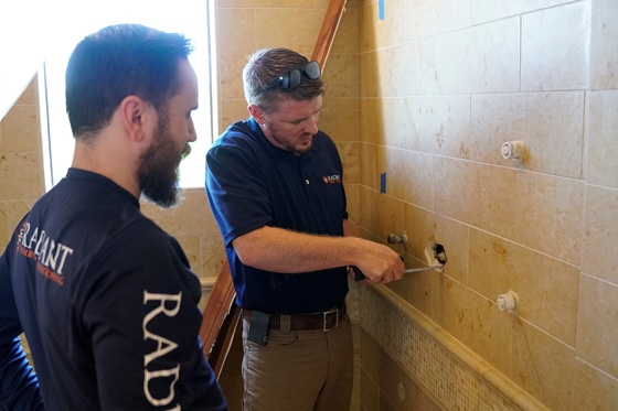 Two Radiant technicians install a new shower faucet