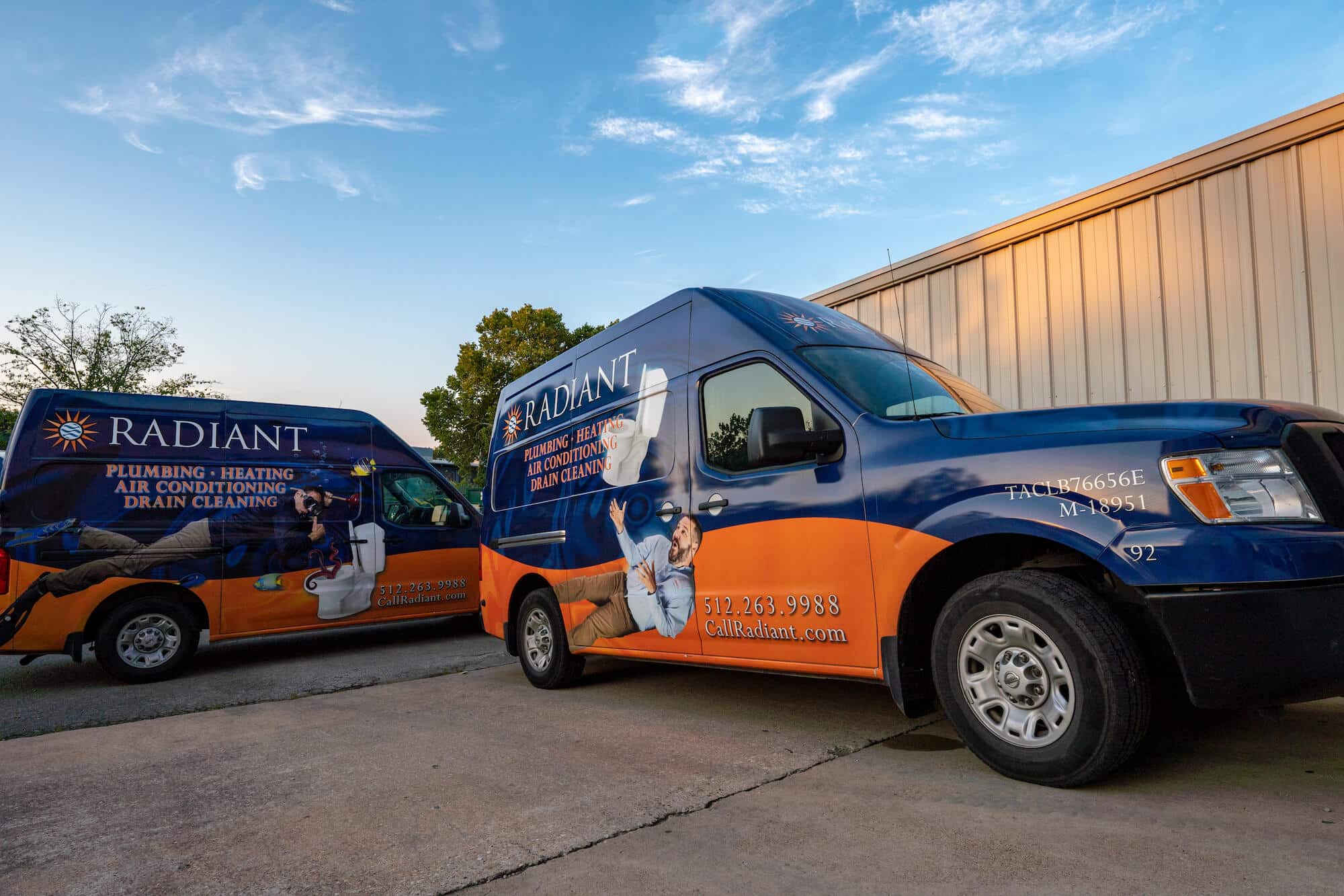 Two Radiant Plumbing, Air Conditioning, & Electrical Trucks parked