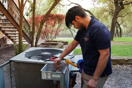 Radiant technician inspecting an outdoor HVAC unit