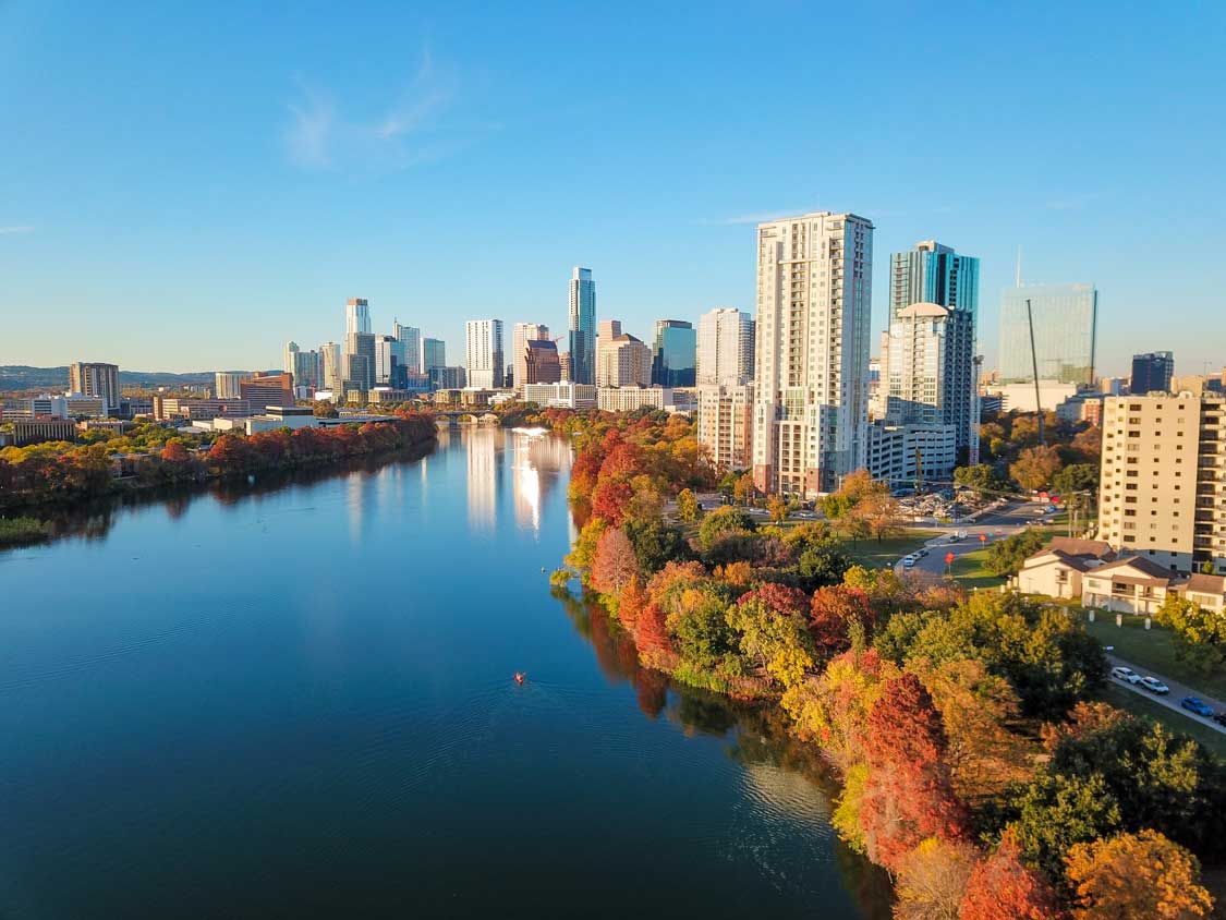 An aerial shot of the Austin skyline in fall along the river