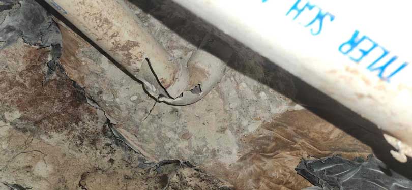 Cracked and leaking sewer pipe under home foundation