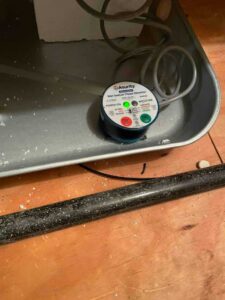 Wet Switch flood detector installed in the secondary drain pan to protect the home from water damage.