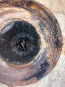 Interior drain with buildup and blockage causing clogs