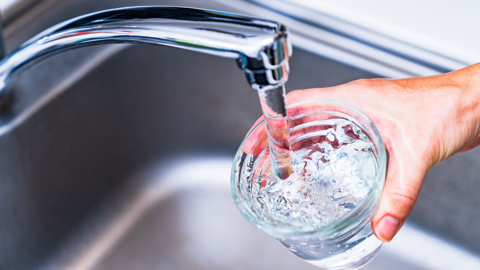 Filling up a clean glass of water at the sink