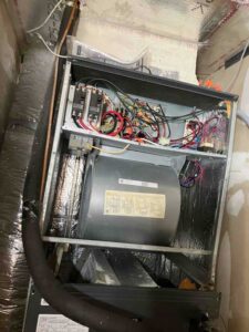 Inside view of HVAC air handler wiring and blower motor during installation