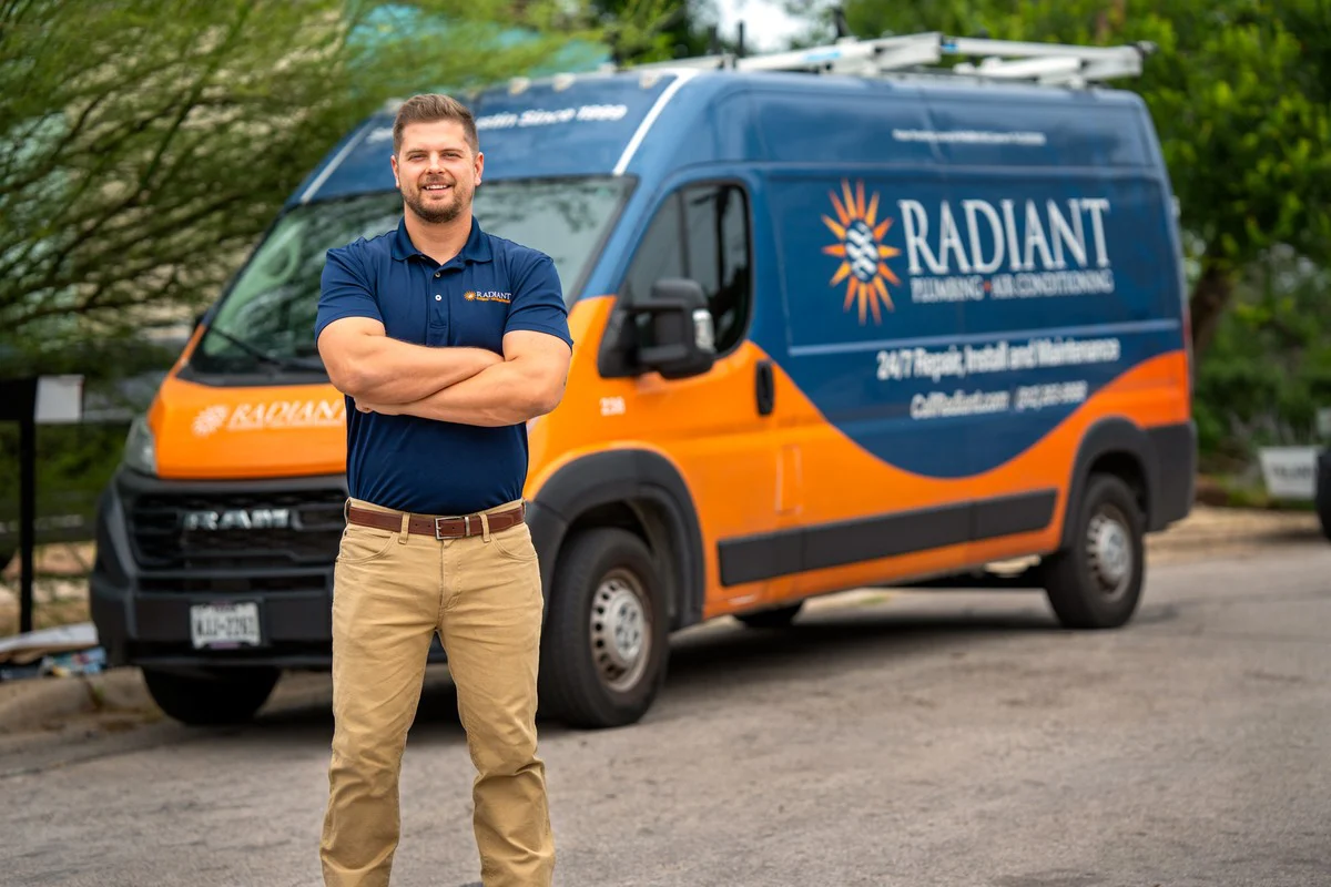 Radiant technician standing in front of a Radiant Plumbing & Air Conditioning service van