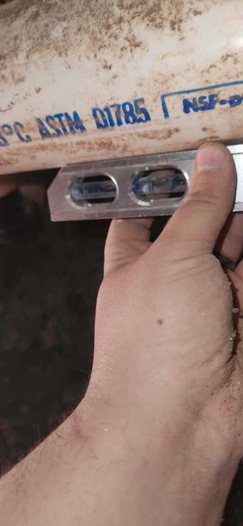 Leveling new PVC drain pipe during installation