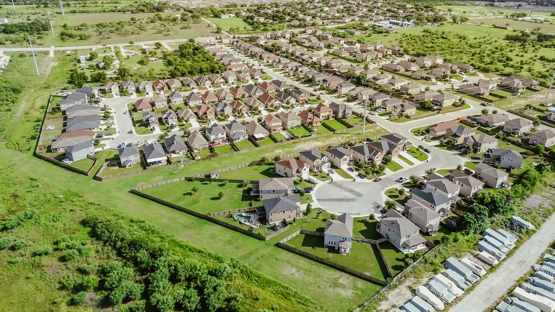 An aerial photo over a typical neighborhood in New Braunfels TX