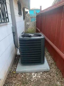 New air conditioner condenser installed on a concrete pad at a San Antonio home