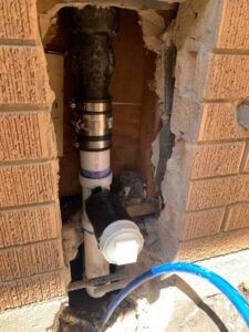 Updated vertical drain connection with secure fittings tied into the new sewer line system.