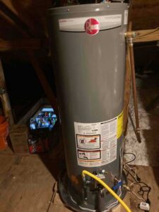 New Rheem water heater installed in attic with gas and water connections