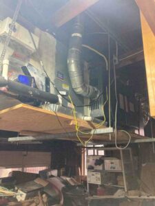 Old gas furnace prior to full system HVAC installation in San Antonio