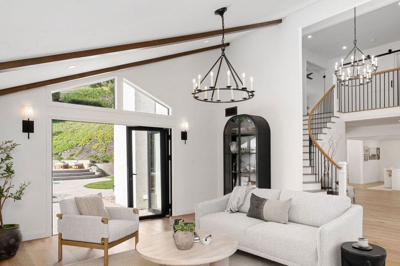 Modern chandelier lighting in an open plan living room and kitchen home