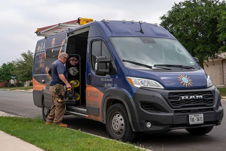 A plumber getting tools from his truck.