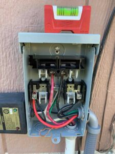 Open HVAC disconnect box showing line and load wiring before installing fuses.