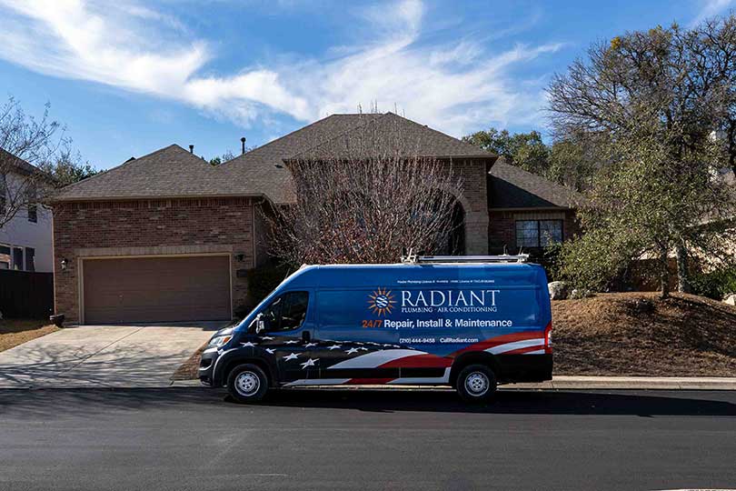 The Radiant Plumbing & Air Conditioning work truck parked in front of a San Antonio home