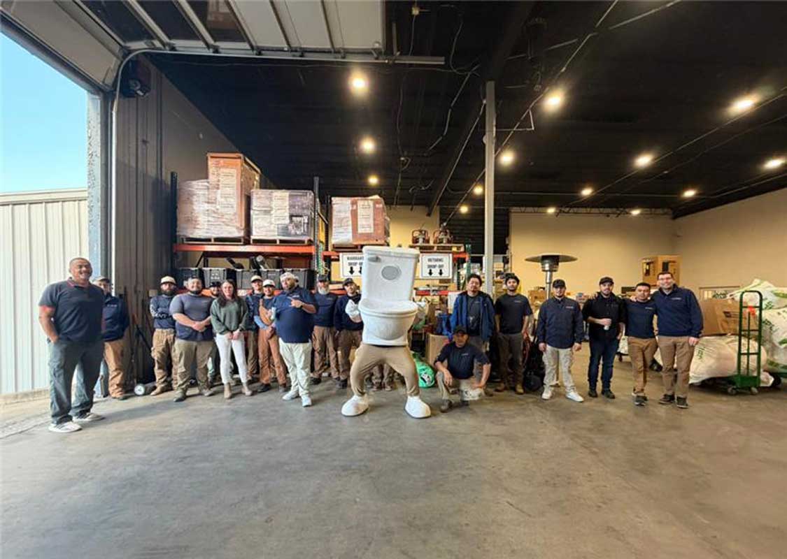 The Radiant Plumbing team in Austin with their mascot Toilet