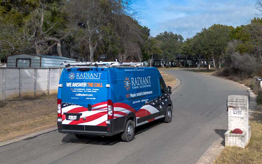 The Radiant Plumbing & Air Conditioning van driving through a neighborhood in San Antonio