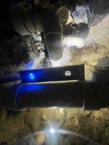 level placed on newly installed sewer pipe to confirm proper slope during drain repair