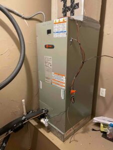 New Trane air handler installed on platform with connected refrigerant and drain lines