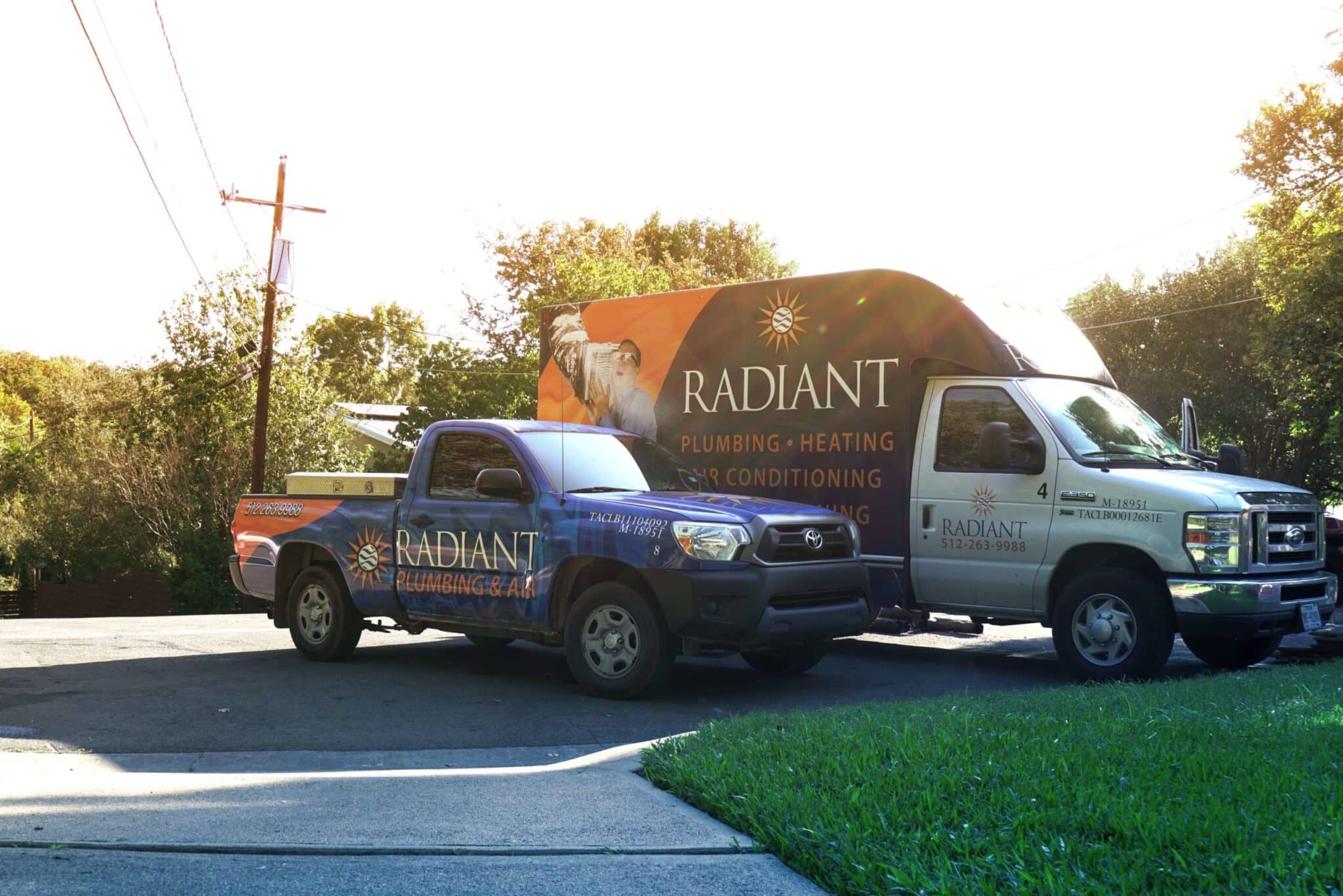 Two Radiant Plumbing trucks parked