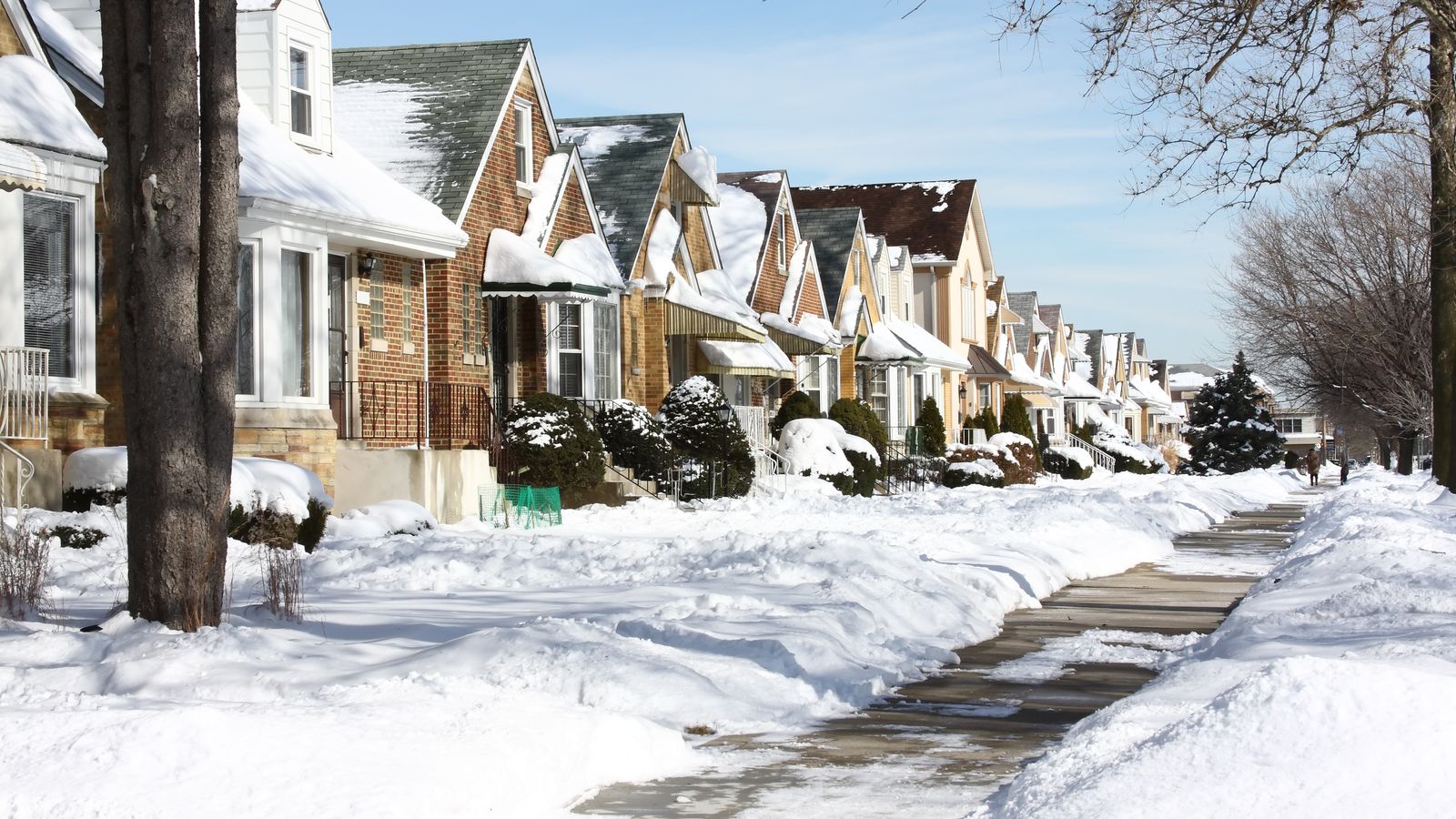 Street scene of homes covered in snow